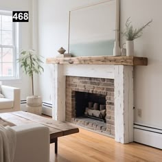 a living room filled with furniture and a fire place in the middle of a wooden floor