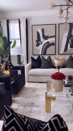 a living room filled with black and white furniture