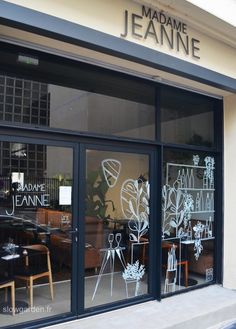 the front window of a restaurant with flowers drawn on it's glass doors and windows