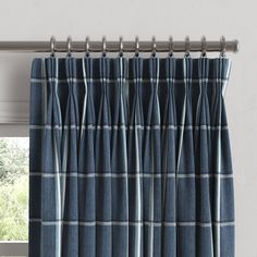 a curtain with blue plaid fabric hanging in front of a window