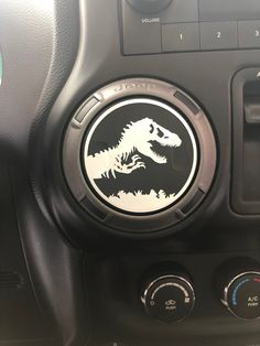 there is a sticker on the dashboard of a car that has a t - rex