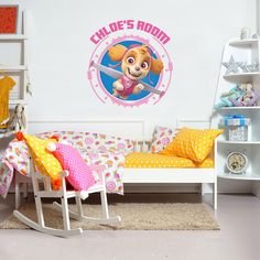 a child's bedroom decorated in pink and yellow with a cartoon dog on the wall