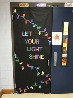 a door decorated with lights and the words let your light shine written in chalk on it