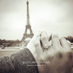 a man and woman holding hands in front of the eiffel tower, paris