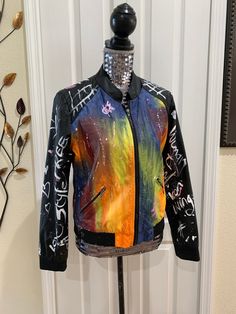 "graffiti jacket,vintage jacket,faux leather,painted jacket,upcycled jacket,love,peace,hand painted coat,splatter jacket Unique One of a kind custom made upcycled painted jacket Be the first to own one of our custom, made to order Fashionable jackets So comfy! Make a Unique fashion statement when wearing. You're guaranteed to attract attention with this unique one of a kind item. Jazz up an everyday outfit, bring some life to the boring outfit and wear as a cover up, wear as a fashion statement Artistic Winter Streetwear Outerwear, Artistic Winter Outerwear For Streetwear, Fall Graffiti Print Outerwear For Streetwear, Fall Streetwear Outerwear With Graffiti Print, Trendy Spring Outerwear With Graffiti Print, Grunge Graffiti Print Outerwear For Fall, Grunge Outerwear With Graffiti Print For Fall, Fall Festival Outerwear With Graphic Print, Graphic Print Outerwear For Fall Festival