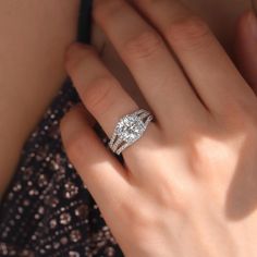 a woman's hand with a diamond ring on it