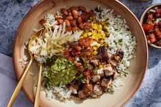 a bowl filled with rice, beans and vegetables