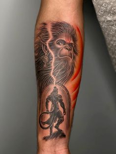 a man's arm with a monkey and demon tattoo on the left side of his arm