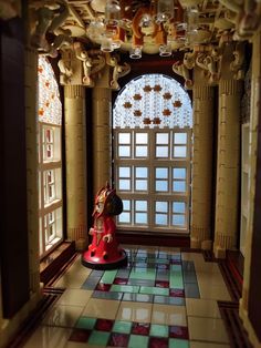 a red fire hydrant sitting on top of a tiled floor next to a window