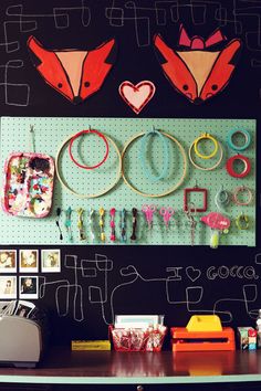 there are many different items on the wall in this crafting area, including scissors and other crafts