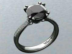 a black and white diamond ring with diamonds on the side, in front of a gray background