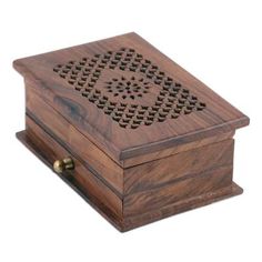 a wooden box with an intricate design on the lid