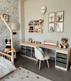 a child's bedroom with a bed, desk and toys