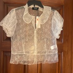 This Ivory Shirt Is Extremely Girly With A Floral Backdrop, But Not, Rounded Collar, And Puffy Sleeves. Perfect To Wear With A Tank. Spring Lace Collar Button-up Shirt, Cider Tops, Sheer Shirt, Floral Backdrop, Puffy Sleeves, Cream White, Round Collar, Cider, Colorful Shirts