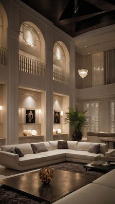 a large living room with high ceilings and white furniture