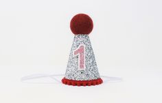 "● This listing: SILVER glitter party hat with MAROON pompom trim/pompom top and MAROON glitter birthday number ● Size: Hats measure 4\" tall by 2.5\" wide, and have skinny elastic headband meant to be worn around the back of the head (not under chin) ● Find all of our cute items here: https://www.etsy.com/shop/CutestLittleDay ● Share: Please tag our sister shop in your photos on Instagram @CutestLittleParty so we can show you some love!" First Birthday Outfit Boy, 1st Birthday Party Hat, First Birthday Hat, 1st Birthday Hats, First Birthday Crown, 2nd Birthday Outfit, First Birthday Hats, Forest Birthday, 1st Birthday Boy