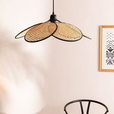 a chair and table in a room with a fan hanging from it's ceiling