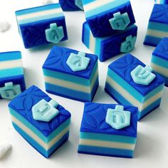 blue and white striped cake pieces with the letter e on them are arranged in rows