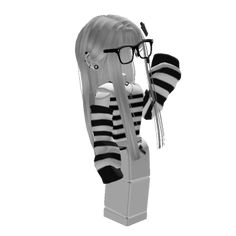 a black and white photo of a doll with glasses on it's head wearing a striped sweater