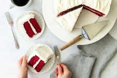 two plates with slices of red velvet cake on them, one being cut and the other is holding a knife