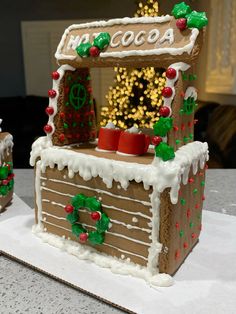 there is a decorated gingerbread house on the table