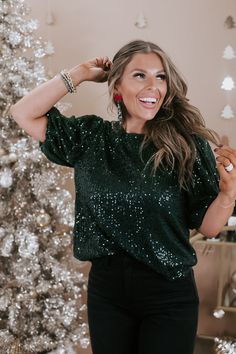 Spread more cheer in our Half Puff Sleeve Sequin Top in a festive green. This stylish top features eye-catching sequins and playful half puff sleeves, adding a touch of glamour to your winter and festive ensembles. Whether you're dressing up for a holiday party or adding flair to a casual look, the More Cheer Sequin Top ensures a statement of style. Green sequins detailing Lining Peek-hole + button closure Half balloon sleeve 100% polyester Imported Model Specs: Karli is wearing a size small in Casual Holiday Party Outfit, Comfy Christmas Outfits, Jollywood Nights, Half Puff Sleeve, Holiday Party Outfit Casual, New Years Eve Outfits Casual, Christmas Outfit Aesthetic, Green Velvet Top, Style Wide Leg Jeans