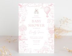 a pink and white baby shower card with an elephant, hot air balloon, flowers, and clouds