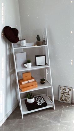 a white shelf with books and other items on it