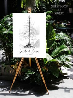 an easel with a sign on it in front of some plants