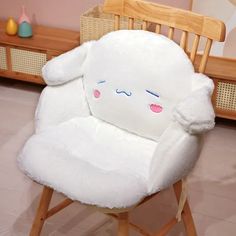 a white chair with a stuffed animal on it's back in a child's room