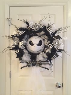 a halloween wreath with a jack skellingy face