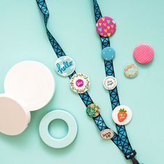 some buttons are on a blue and black cord with other items around it, including a pacifier