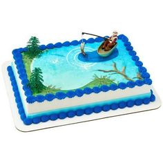 a birthday cake with a man in a boat on the water