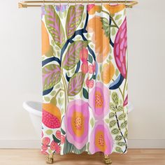 a shower curtain with colorful flowers and leaves on it, hanging from the side of a bathtub