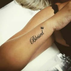 a woman's arm with a tattoo that reads, beloved on the left side