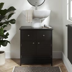 a bathroom with a sink, mirror and rug