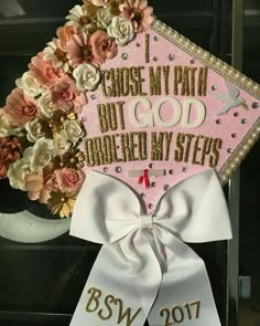 a pink and white graduation cap with flowers on the side that says, i choose my math but god answered my steps