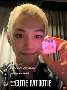 a woman holding up a pink object in front of her face with the caption cutie patoote love