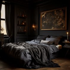 a large bed in a dark room with a painting on the wall