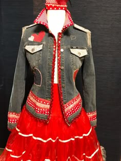 a red dress and jean jacket on display