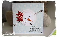 a close up of a snowman card on a table