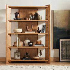 a bookshelf filled with lots of different types of items on top of it