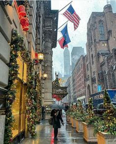 people walking down the street with umbrellas in the rain