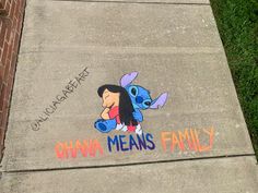 the sidewalk has been decorated with chalk and markers for children to draw on it, including an image of cartoon characters