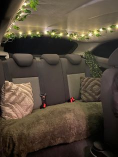 the interior of a car with christmas lights on the ceiling and decorative decorations in the passenger area