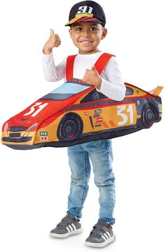 a young boy wearing a race car costume and giving the thumbs up while standing in front of a white background