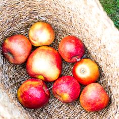 a basket filled with lots of red apples