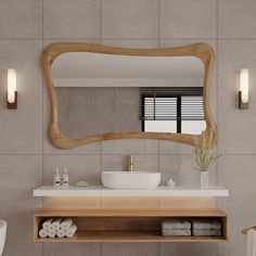 a bathroom with a sink, mirror and towels on the shelf in front of it