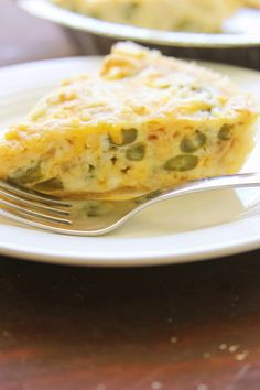 a slice of quiche on a plate with a fork