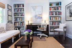 a living room filled with furniture and bookshelves